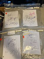 Four plastic resealable bags each containing a different autographed TV show script, labeled with show name and episode details.