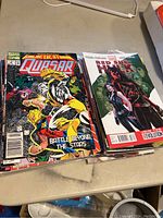 Stack of comic books showing Marvel's Quasar Galactic Storm issue on top and Red She-Hulk comic book.