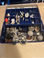Wide view of Star Wars miniature collection in storage case, showing multiple rows of small ships and figures sorted in compartments.