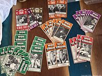 Top view of multiple stacks of vintage CHFM and CHUM radio fan cards arranged on wooden surface.