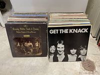 Two stacks of vinyl records showing front covers of Crosby, Stills, Nash & Young and The Knack albums