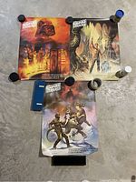 Three Star Wars Empire Strikes Back posters laid flat, held down with weights, showing wear and vintage colors.