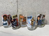 Photo of the complete set of five 1977 Burger King Star Wars promotional glasses showing full character artwork and logos on each glass.