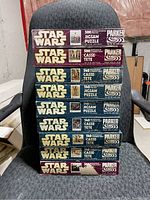 Stack of nine Star Wars jigsaw puzzle boxes showing various sizes and conditions