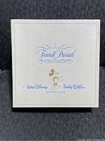 White game box cover with vintage Mickey Mouse illustration and blue Trivial Pursuit and Walt Disney Family Edition branding.