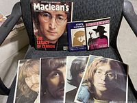 Photo showing collection of Beatles and John Lennon memorabilia including Maclean's magazine and mini posters.