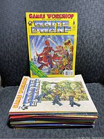 Stack of 18 White Dwarf magazines showing front cover of issue #140 with Games Workshop branding and fantasy artwork.