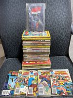 Stack of 26 comic digests and puzzle books featuring Marvel and DC superheroes. Various titles visible including Avengers, X-Men, Spider-Man, Fantastic Four, Captain America, Hulk, Doctor Strange, Superman, and Justice League of America.