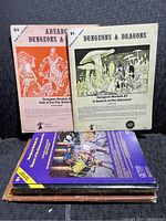 Photo of stacked RPG books showing covers and titles, including Dungeons & Dragons modules B1 and G3.