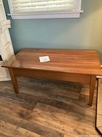 Photo of the full wooden coffee table showing surface and legs