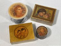 Overview of four trinket boxes: two rectangular with paintings of mother and child, two round marble boxes with portraits of women.