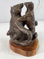 View of mother bear with two cubs clay sculpture on wood base showing general form and condition
