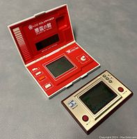 Two handheld electronic games together: Nintendo Game & Watch PR-21 and Bandai LCD Solarpower Akuryo No Yakata