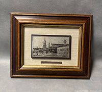 Full view of framed artwork featuring silver etching of Italian cityscape within wood frame.