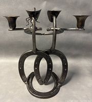 Front view showing two candle arms and horseshoe base