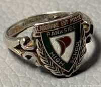 Close-up of the front and side of the sterling silver Parkside High School ring showing detailed enamel emblem and decorative band.