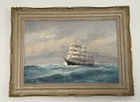 Full view of framed oil on board showing sailing ship on ocean