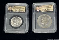 Both coins sealed in plastic protective holders showing front facing portraits of Kennedy and Eisenhower with labels.