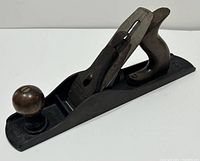 Full view of the vintage Stanley Bailey No.5 wood planer showing metal base, wooden front knob and rear handle.