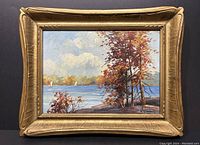 Full view of framed oil painting on black background