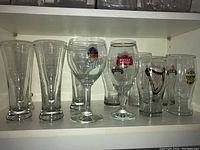 Front view showing variety of beer glasses including Leffe, Stella Artois, and plain glasses