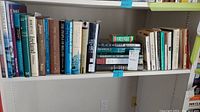 Books lined up on white shelving spanning topics of Irish heritage, history, and language.