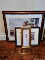 Four framed prints grouped together, showing variety of sizes and frame styles, with one large 19x23 print and several smaller prints.