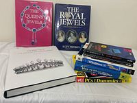 All books displayed together showing a mix of coffee table books and computer self-help guides in varied colors and sizes