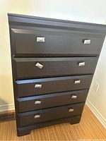 Front view of the five drawer high boy bureau in dark wood finish.