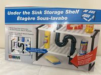Box front showing under the sink storage shelf with segmented shelving to allow space for plumbing pipes. Holds cleaning items like sponges, spray bottles, soap.