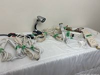 Overview of cords, power bars and adjustable light on white cloth