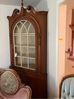 Full front view of the corner cabinet showing overall design and finish