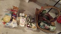 Full lot view showing a basket with boxed home fragrance products, and plastic bins containing various soaps and car air fresheners.