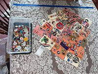 Top-down view of plastic bin and loose campaign buttons on table