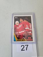 Front photo of Adam Oates rookie hockey card in protective sleeve showing player in Detroit Red Wings jersey