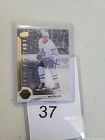 Front of Auston Matthews hockey card showing player in Toronto Maple Leafs uniform with 'Shining Stars' gold foil.
