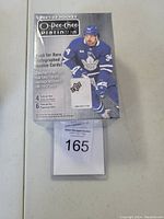 Front of the sealed 2021-22 O-Pee-Chee Platinum Hockey blaster box showing a Toronto Maple Leafs player and product branding.