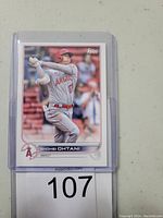 Front of Shohei Ohtani baseball card in protective casing, showing the player in action.