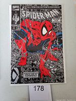 Front cover of Spider-Man #1 comic book showing black and silver cover with red and blue Spider-Man figure crouching.