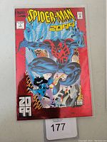 Front cover of Spider-Man 2099 #1 comic book showing Spider-Man in blue and red futuristic suit swinging in cityscape with 2099 branding.