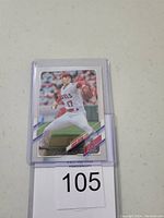 Front view of Shohei Ohtani baseball card in protective sleeve showing him pitching in Angels uniform.
