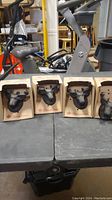 Four boxed moose head shaped bottle openers arranged side by side