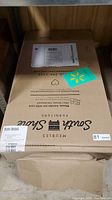 Cardboard box with South Shore Furniture logo, sealed shipping label from Walmart visible.