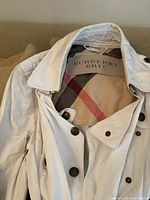 White Burberry Brit jacket displaying label and interior check pattern