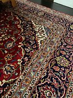 Full view of red field and border beneath a bed