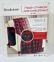 Front of the product box showing brand, item type, dimensions, heat settings, fabric softness, auto-off feature, and remote control.