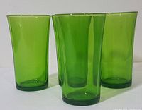 Three emerald green Duralex beverage glasses from France shown together