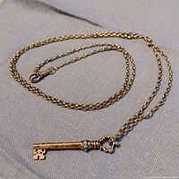 Full view of pendant and chain laid flat showing clasp and pendant orientation