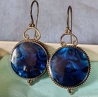 Front view of both earrings on fabric