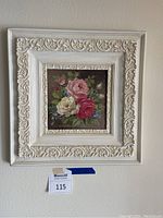 First framed acrylic rose print featuring red, pink, and white roses with ornate white frame